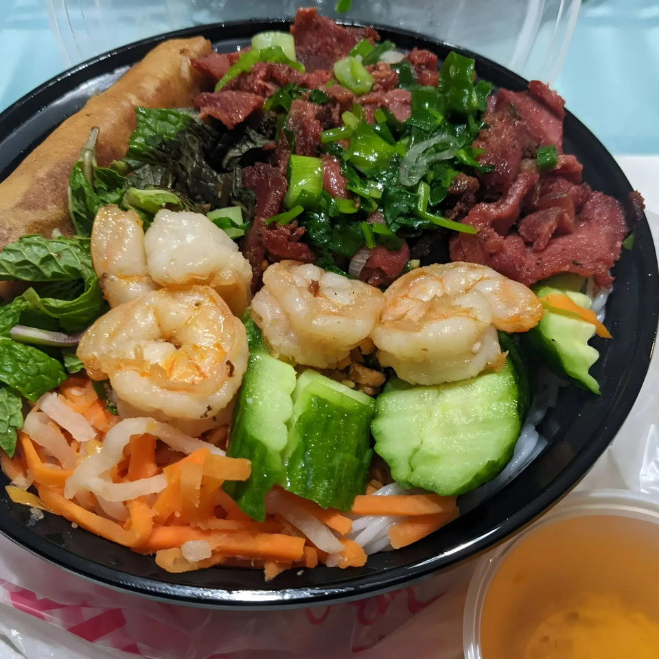 BMC Pho's Vietnamese vermicelli bowl with shrimp, beef, spring roll, and fresh vegetables.