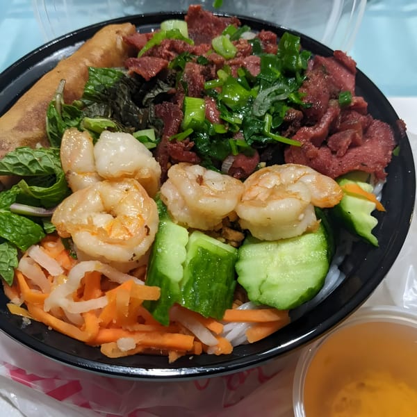 BMC Pho's Vietnamese vermicelli bowl with shrimp, beef, spring roll, and vegetables.