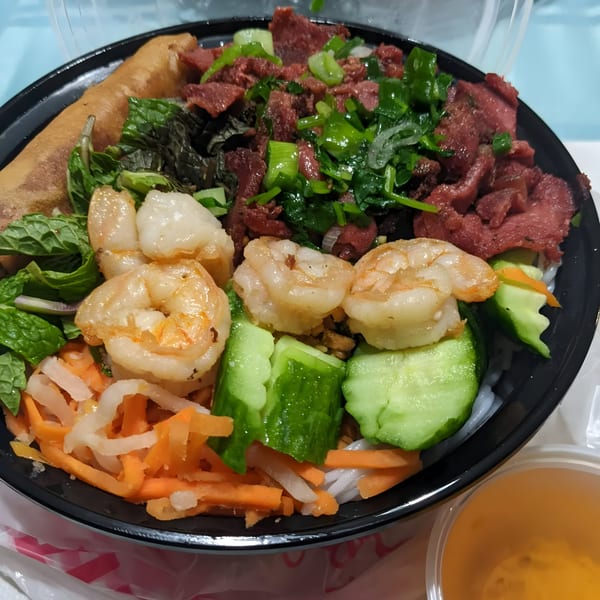 BMC Pho's Vietnamese vermicelli bowl with shrimp, beef, spring roll, and vegetables.