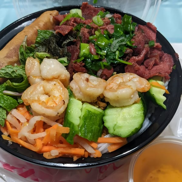 BMC Pho's Vietnamese vermicelli bowl with shrimp, beef, spring roll, and fresh vegetables.