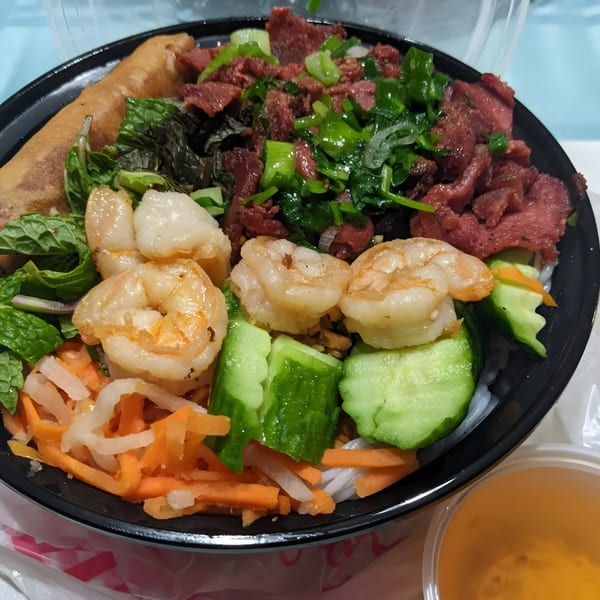 BMC Pho's Vietnamese vermicelli bowl with shrimp, beef, spring roll, and fresh vegetables.